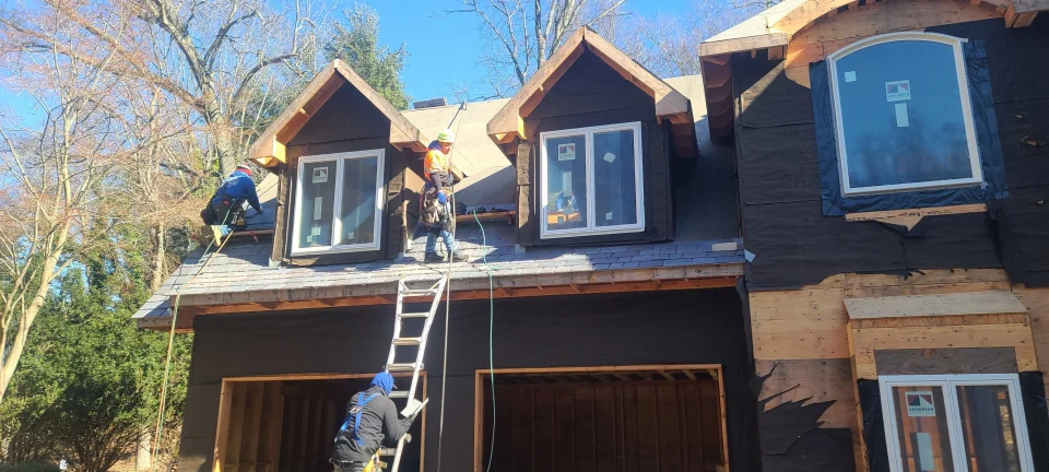 a group of men working on a house