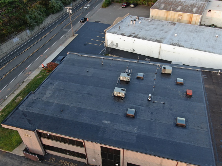 a rooftop of a building with cars parked on the side of it