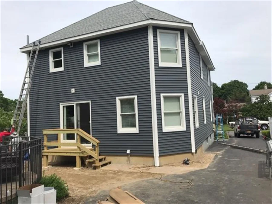 a house with a ladder and a fence
