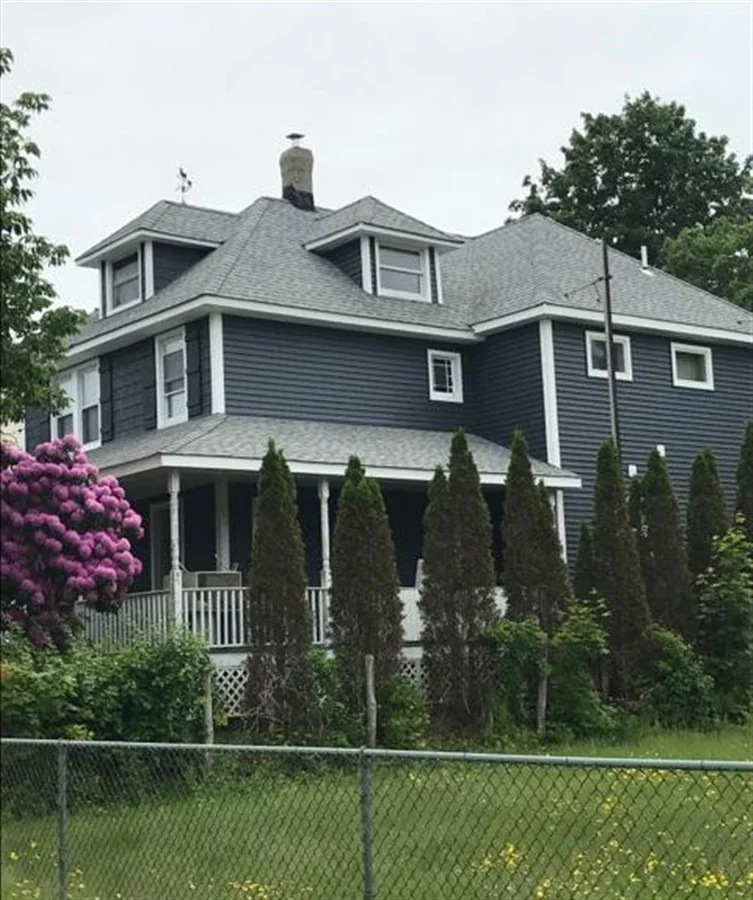 a house with trees and a fence
