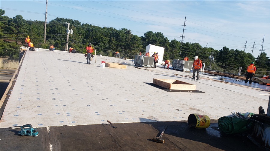 a group of men working on a roof