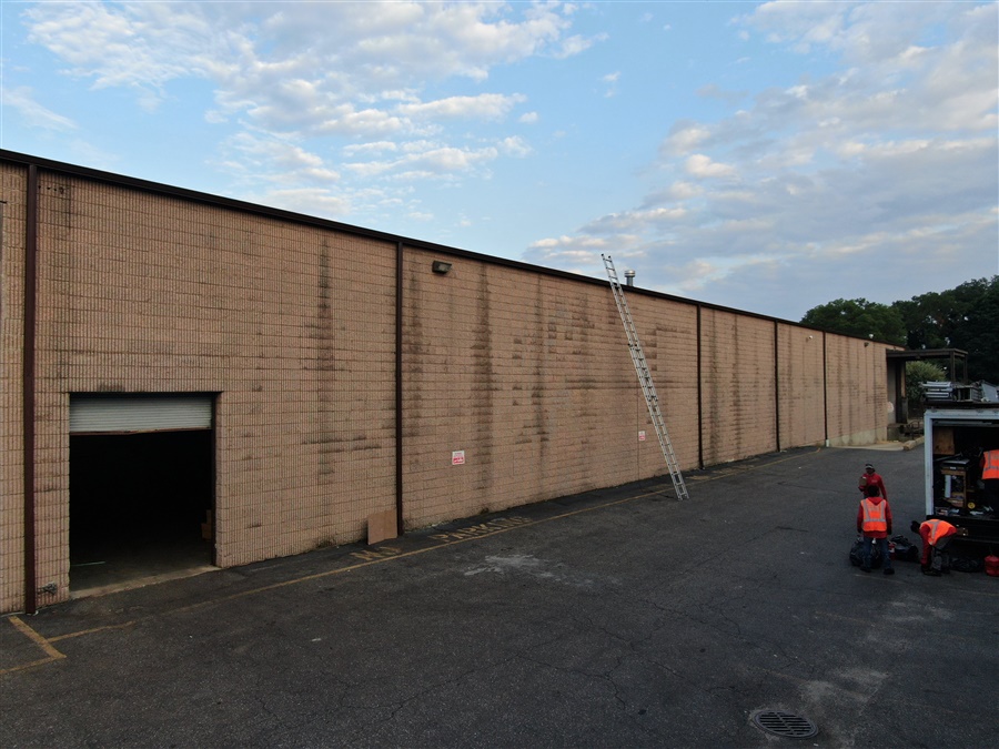 a man standing next to a building